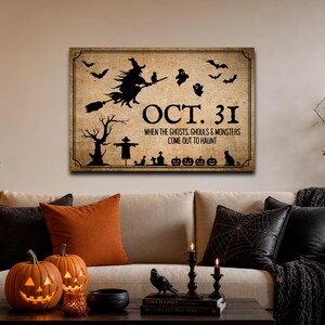 May include: A rectangular wall sign with a vintage beige background featuring black silhouettes of a witch on a broom, bats, ghosts, a tree, a scarecrow, and pumpkins. The text reads OCT. 31 WHEN THE GHOSTS, GHOULS & MONSTERS COME OUT TO HAUNT.