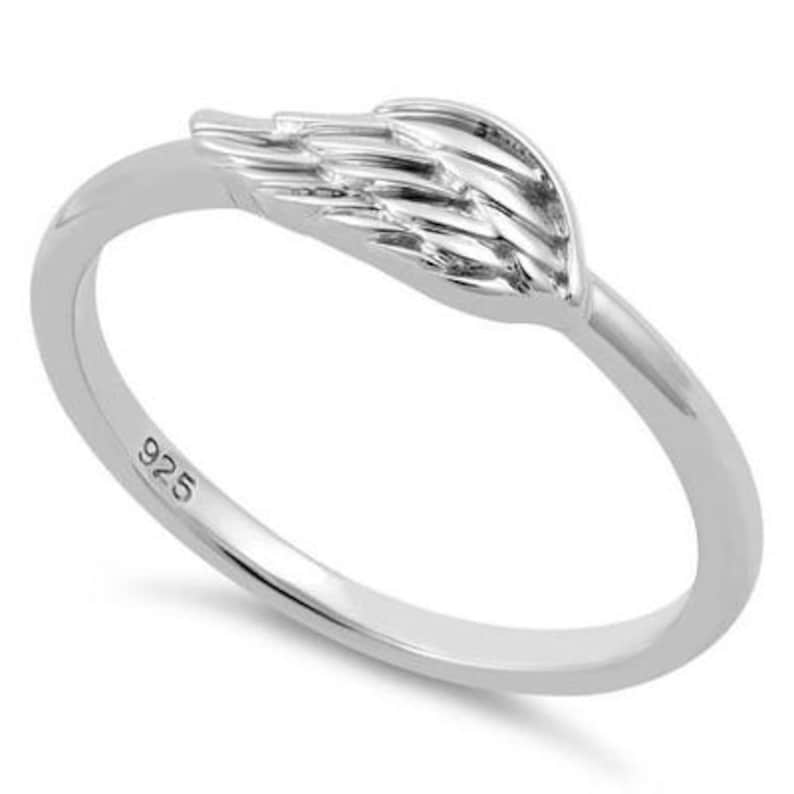 May include: Sterling silver ring featuring a wing design. The ring is hallmarked with "925" on the inside.