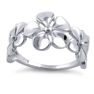 May include: Sterling silver ring featuring a design of four delicate flower blossoms. The ring is a simple and elegant piece of jewelry.
