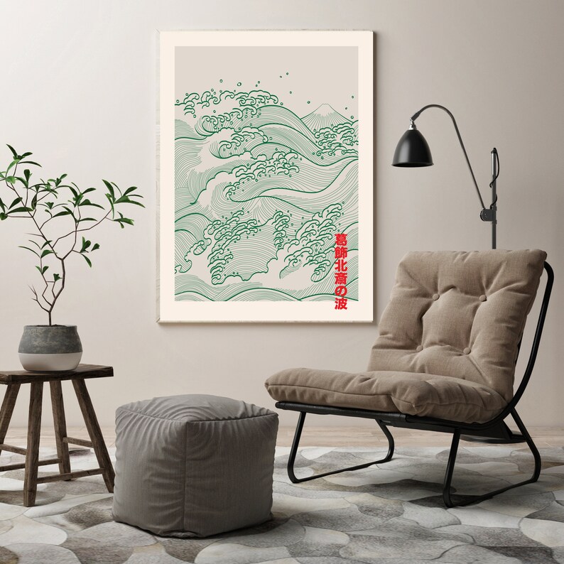May include: A framed print of a green and white wave design with the Japanese text "波 北部 の" in red. The print is hanging on a wall above a brown armchair with a black metal frame.