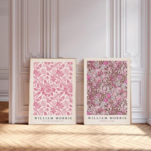 May include: Two framed prints of floral patterns by William Morris. The left print features a pink chrysanthemum pattern, and the right print features a golden lily pattern.