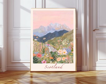 May include: A framed art print featuring a landscape scene of Scotland. The artwork depicts a mountain range with snow-capped peaks, rolling hills, and a field of colorful wildflowers. The word "Scotland" is written in a cursive font at the bottom.