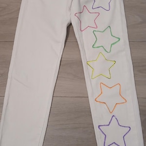 White Denim size 2 waist 24 with Multi Colored Outlined Stars