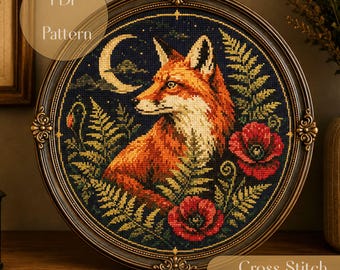 May include: A circular cross stitch pattern featuring a fox in profile against a dark blue night sky with a crescent moon, green fern leaves, and red poppy flowers, all enclosed in an ornate, dark brown, vintage-style oval frame.