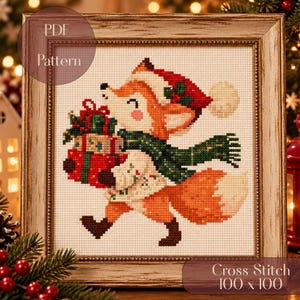 Könnte beinhalten: Ein Kreuzstichmuster mit einem Fuchs, der eine rote Weihnachtsmütze und einen grünen Schal trägt und Geschenke trägt. Das Motiv ist in einem hellen Holzrahmen. Der Text lautet PDF Pattern und Cross Stitch 100 x 100.
