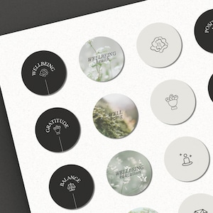 May include: A set of 12 round stickers with various designs and text related to wellbeing. The stickers are black and white with a light gray background. The text on the stickers includes "Wellbeing", "Gratitude", "Balance", "Affirmation", "Positivity", "Wellbeing health", "Wellbeing education", and "Well being".