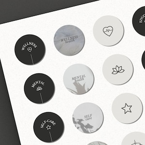 May include: A set of 12 black and white round stickers with various wellness-related icons and text. The icons include a heart with a heartbeat line, a lotus flower, a star, and a brain. The text includes "Wellness", "Wellness health", "Mental health", "Self care", "Education", "Affirmation", and "Quote".