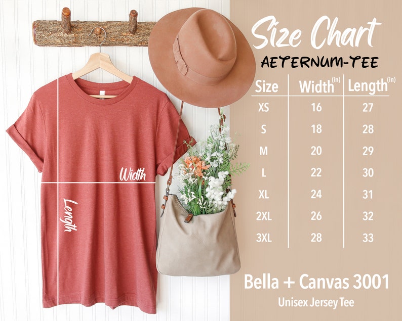 May include: A rust-colored Bella + Canvas 3001 Unisex Jersey Tee hangs on a wooden rack. A size chart displays measurements in inches, with sizes ranging from XS to 3XL. The chart includes the text "AETERNUM-TEE". A brown hat and a beige bag with flowers are also visible.