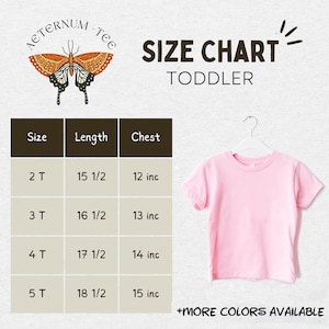 May include: A pink toddler t-shirt hanging on a white hanger, with a size chart. The chart shows sizes 2T to 5T, with chest measurements from 12 to 15 inches. The shirt has the text "AETERNUM-TEE" and "SIZE CHART TODDLER".