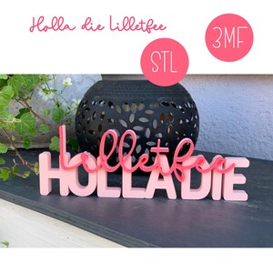 May include: A pink wooden sign with the words "Holla die lilletfee" in a playful font. The sign is in front of a black decorative lantern and greenery. Two pink circles with the text "STL" and "3MF" are in the background.
