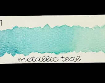May include: A rectangular watercolor swatch on white paper, featuring a gradient of metallic teal paint. The text "no. 111" is at the top left, and "metallic teal" is written at the bottom.