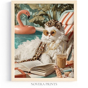 May include: A framed print depicting a white cat in sunglasses and a leopard print scarf, relaxing by a pool with a flamingo inflatable. The cat is reading a book and has a drink. The print is labelled "NOVERA PRINTS".