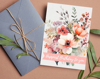 May include: A birthday card with a watercolour floral design in peach, pink, and red hues. A grey envelope tied with twine sits beside the card. The card reads "Happiest Birthday to you". The words "Digital Download" are in the top right corner.