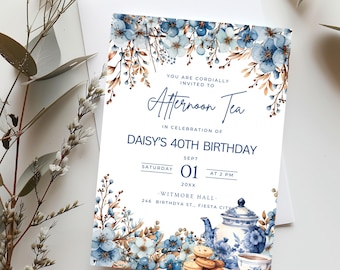 May include: A blue and white floral invitation for an afternoon tea party celebrating a 40th birthday. The invitation features a teapot, teacups, and cookies. The text reads "You are cordially invited to Afternoon Tea in celebration of Daisy's 40th Birthday. Saturday, Sept 01, 20XX at 2 PM. Witmore Hall, 246 Birthdya St., Fiesta City."