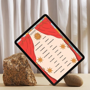 May include: A digital tablet displaying a tarot card layout with the words "Major Arcane" at the top. The screen shows a red curtain design with a sun graphic and star accents. The tablet is propped up by a large rock and a small stone.
