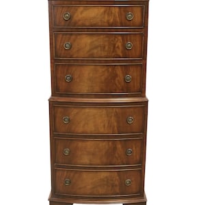 May include: A tall, wooden chest of drawers with a dark brown finish. The chest has six drawers, each with a brass knob. The top section has straight drawers, while the bottom section has curved drawers. The chest sits on short, curved feet.