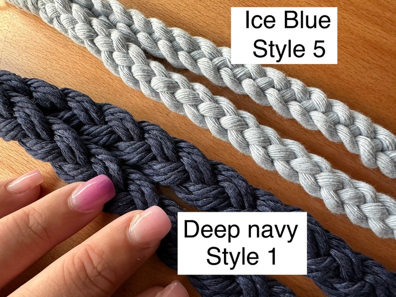 Two blue macrame lanyards, showing style 1 and style 5. 1 is deep navy braid, style 5 is a celtic 4 strand round braid in color ice blue. They are laid out flat on a wooden background.l