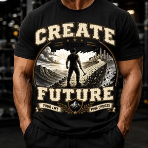 May include: A black short-sleeve t-shirt featuring a graphic print with the text CREATE YOUR FUTURE, YOUR LIFE, and YOUR CHOICES. The illustration depicts a person standing on a path holding a hammer, overlooking a landscape with mountains and a city skyline at sunrise.