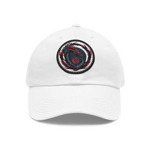 May include: White baseball cap with a black and red dragon design in a circle on the front.