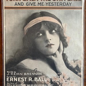 May include: Vintage sheet music cover featuring a black and white portrait of a woman with the title "TURN BACK THE UNIVERSE AND GIVE ME YESTERDAY." The cover includes the names of the lyricist, composer, and a list of other songs.