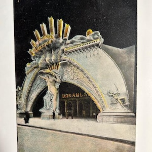 May include: Vintage postcard depicting the entrance to Dreamland, Coney Island, N.Y. The image shows a grand archway with the words "Dreamland" and "Creation" in gold lettering. A statue of a woman stands beneath the arch.