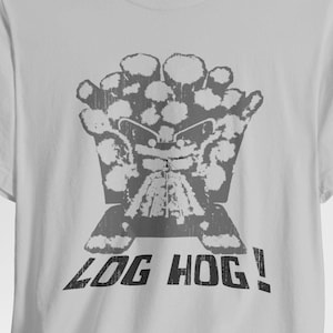 May include: A light gray t-shirt with a black and white graphic of a cartoon character with the text "LOG HOG!" printed on the front.