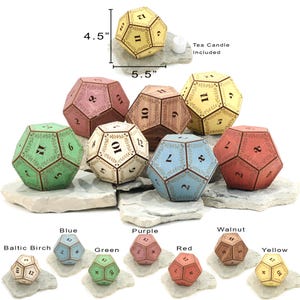 May include: A collection of dodecahedron-shaped candle holders in various colors, including yellow, red, green, and blue. Each holder is approximately 5.5 inches wide and 4.5 inches tall, with numbers and decorative leaf patterns. A tea candle is included.