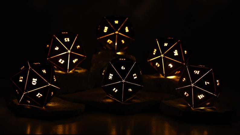 May include: Six illuminated, geometric dice with white numbers and golden light. The dice are arranged on a dark surface, creating a warm, inviting glow against the black background. A unique decorative item for tabletop gaming enthusiasts.