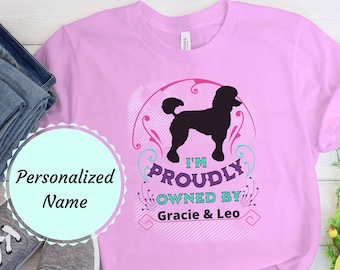 May include: Pink t-shirt with a black poodle silhouette and the text "I'm Proudly Owned By Gracie & Leo".