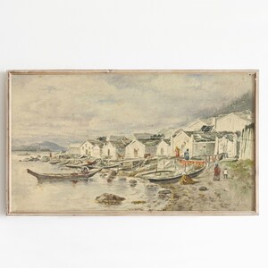 May include: A watercolour painting depicting a coastal village with white houses and boats on the water. The scene is set on a cloudy day with a light blue sky and a distant mountain range. The painting is framed in a simple wooden frame.