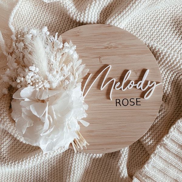 Baby name announcement sign with dried flowers different fonts