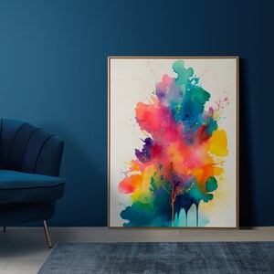Puede incluir: Pintura abstracta de acuarela de un árbol colorido con salpicaduras de rosa, amarillo, azul, verde y morado sobre un fondo blanco. La pintura está enmarcada en un marco de madera claro.