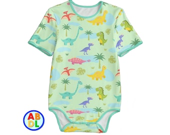 May include: A light green baby onesie with a short sleeve and a white trim. The onesie has a pattern of colorful dinosaurs and palm trees.