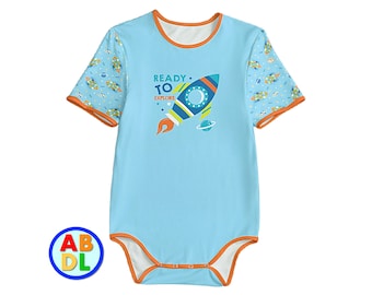 May include: A light blue short-sleeved bodysuit with an orange trim. The bodysuit has a rocket ship graphic with the text "READY TO EXPLORE". The sleeves have a space-themed print.