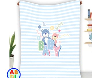 May include: A blue and white striped baby blanket with a colorful "BABY" graphic and two teddy bears. The bears are blue and pink and have a playful design.