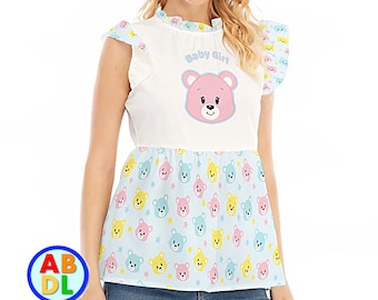 May include: White short-sleeved shirt with a pink teddy bear graphic and the text "Baby Girl". The bottom of the shirt is a light blue fabric with a pattern of pink, yellow, and blue teddy bears.
