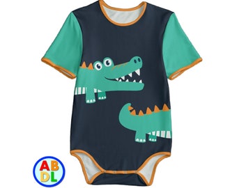 May include: A dark blue baby onesie with short sleeves and a yellow trim. The onesie features a green crocodile with orange teeth and eyes. There is a smaller green crocodile with orange teeth and eyes on the bottom of the onesie.