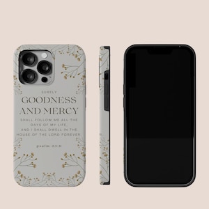 May include: A white phone case with a floral design and a quote from Psalm 23:6, "Surely goodness and mercy shall follow me all the days of my life, and I shall dwell in the house of the Lord forever."