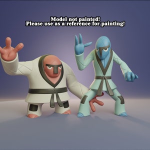 May include: Two unpainted figurines of martial arts characters. One is in a white gi with a black belt and a red face. The other is in a light blue gi with a gray belt and a blue face. Text on top says "Model not painted! Please use as a reference for painting!"