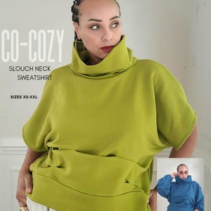 May include: A lime green slouch neck sweatshirt with short sleeves. The sweatshirt has a high, folded collar and a wide, relaxed fit. The text "CO-COZY SLOUCH NECK SWEATSHIRT" is printed on the image, along with "SIZES XS-XXL" and "KEECHII B STYLE".