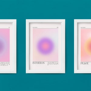 May include: Three framed prints with pink, purple, and yellow gradient backgrounds. Each print features a circle in the center and text below the circle. The text on the prints reads "Clarity", "Intuition", and "Peace".