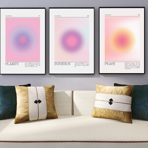 May include: Three framed abstract art prints with a gradient background and a circle in the center. The prints are titled "Clarity", "Intuition", and "Peace".
