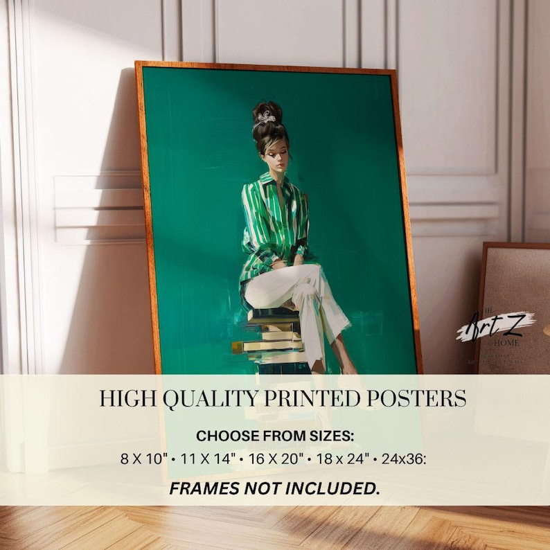 May include: A framed art print featuring a woman in a green and white striped shirt and white pants, seated on a stack of books. The artwork has a teal background and a wooden frame. The print is labeled "HIGH QUALITY PRINTED POSTERS".