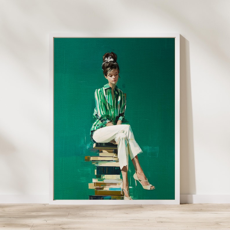 May include: An art print featuring a woman in a green and white striped shirt and white pants, seated on a stack of books. The background is a solid green color, and the woman is wearing beige heels. The artwork is framed in a white border.