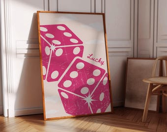 May include: A pink and white poster with two dice and the word "Lucky" printed on it. The dice are in a vintage style with a distressed look.