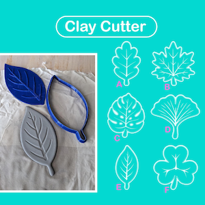May include: A set of leaf-shaped clay cutters featuring a blue outline cutter and two solid leaf-shaped stamps in blue and gray. The image includes text labeled Clay Cutter and six distinct leaf designs marked A through F in white outlines.