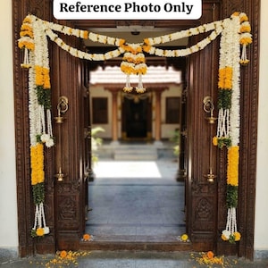 May include: A wooden doorway adorned with floral garlands in white, yellow, and green. The garlands are draped across the top and sides of the door frame. The text "Reference Photo Only" is visible above the door.