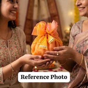 Puede incluir: Una bolsa de regalo naranja con una parte superior con volantes es sostenida entre dos personas. La bolsa es de color naranja vibrante, con una parte superior con volantes de color naranja claro y melocotón. El texto "Reference Photo" está en la parte inferior.