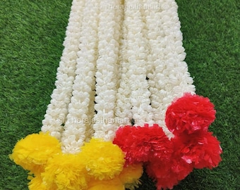 May include: A bunch of white flower garlands with yellow and red flower accents. The garlands are made of artificial flowers and are perfect for decorating for a special occasion.