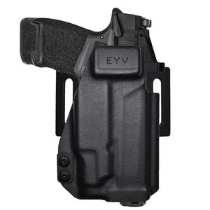 May include: Black handgun in a black holster. The holster has the letters "EYV" embossed on the front. The handgun is partially visible, with a textured grip. The holster has a belt clip.